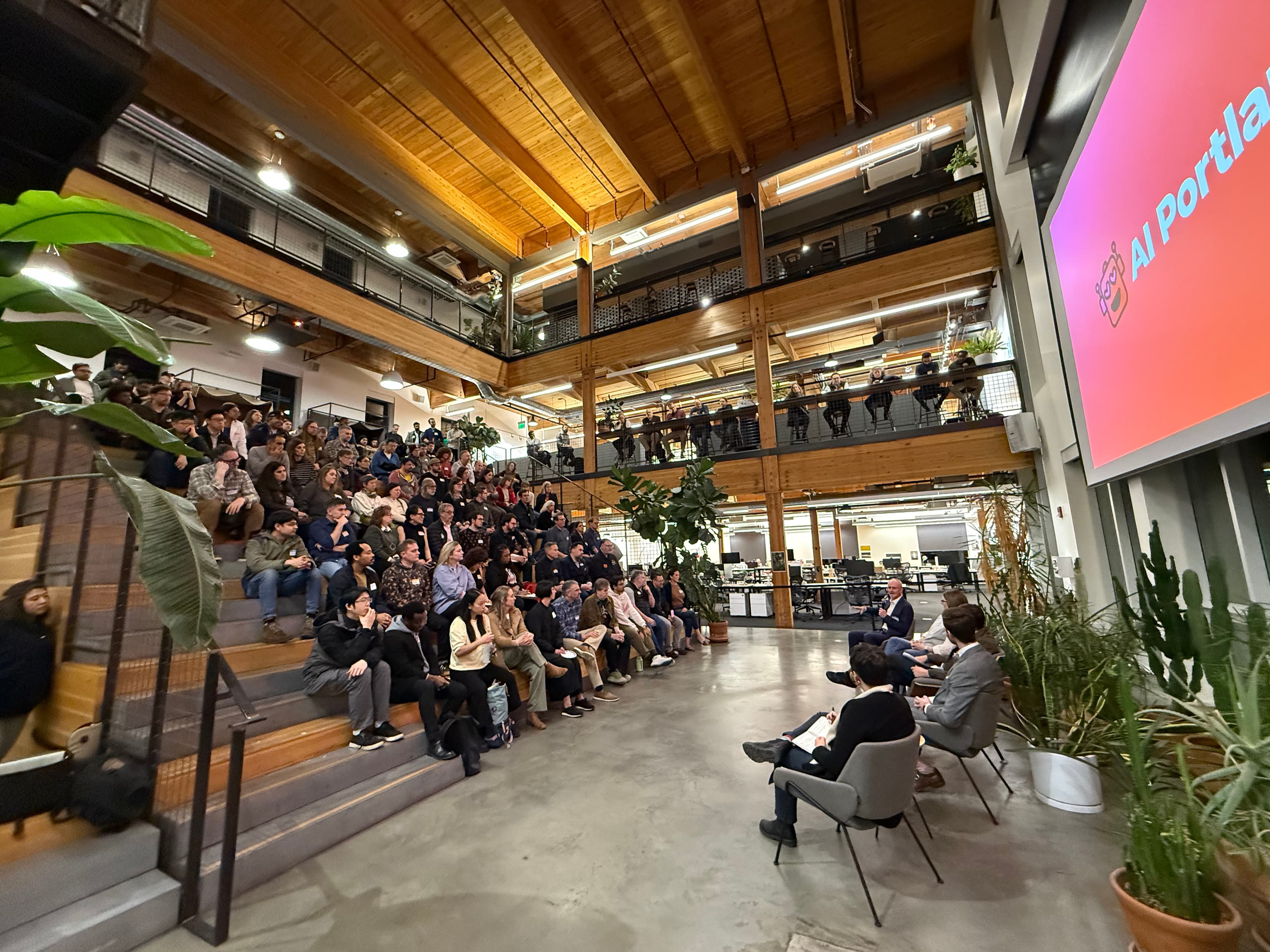 A packed multi-level venue during an AI Portland event