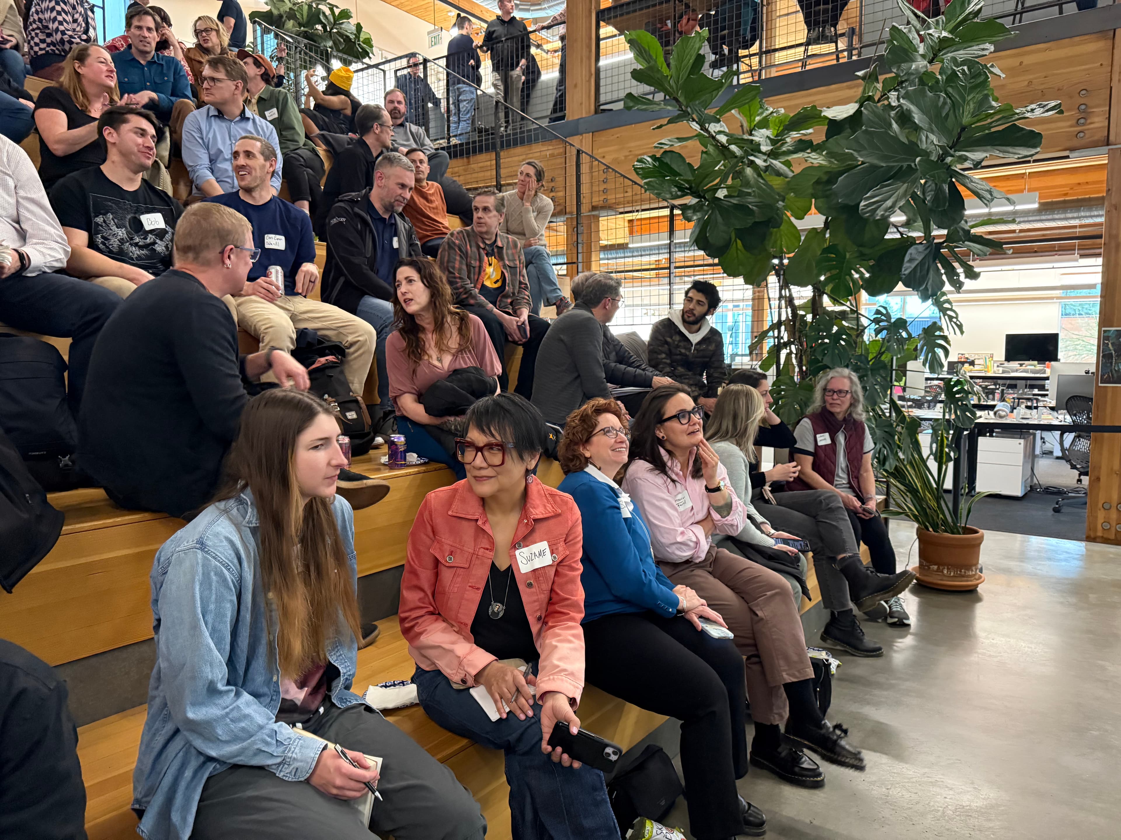 Attendees seated on bleacher-style steps at an AI Portland event