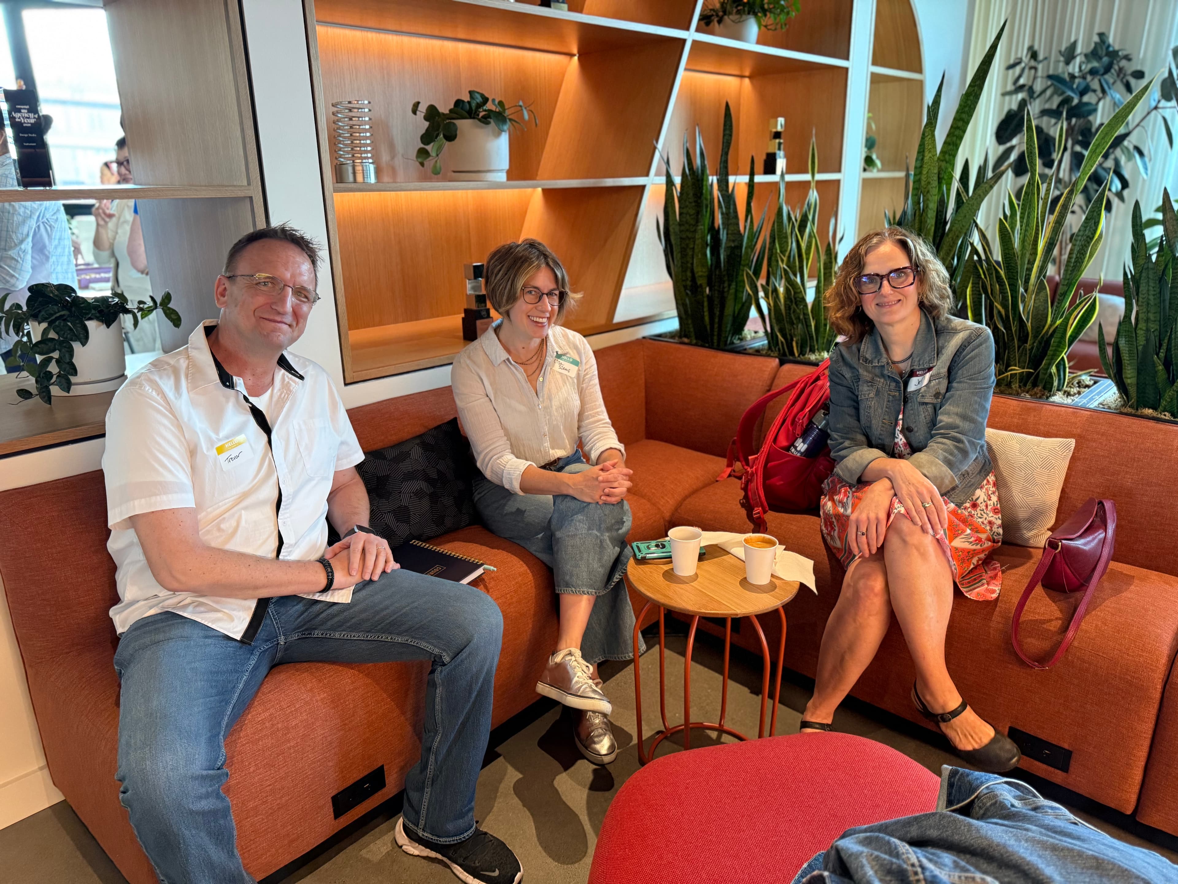 Three AI Portland members chatting on a couch